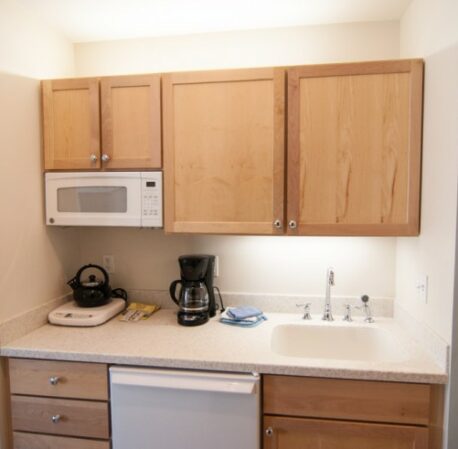Kitchen with microwave and coffee machine, refrigerator in a hotel room