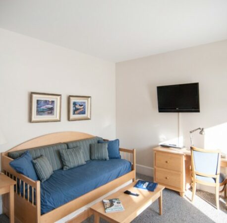 Room with kitchen and soft sofas, large windows, table, TV in Beachmere West