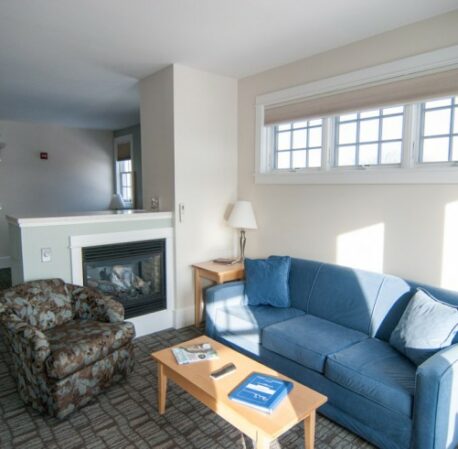 Living room with soft sofas, large windows, table in Beachmere West