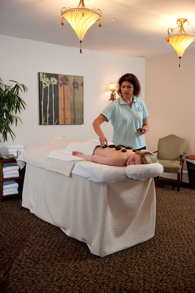 Massage Therapist performing a hot stone massage.