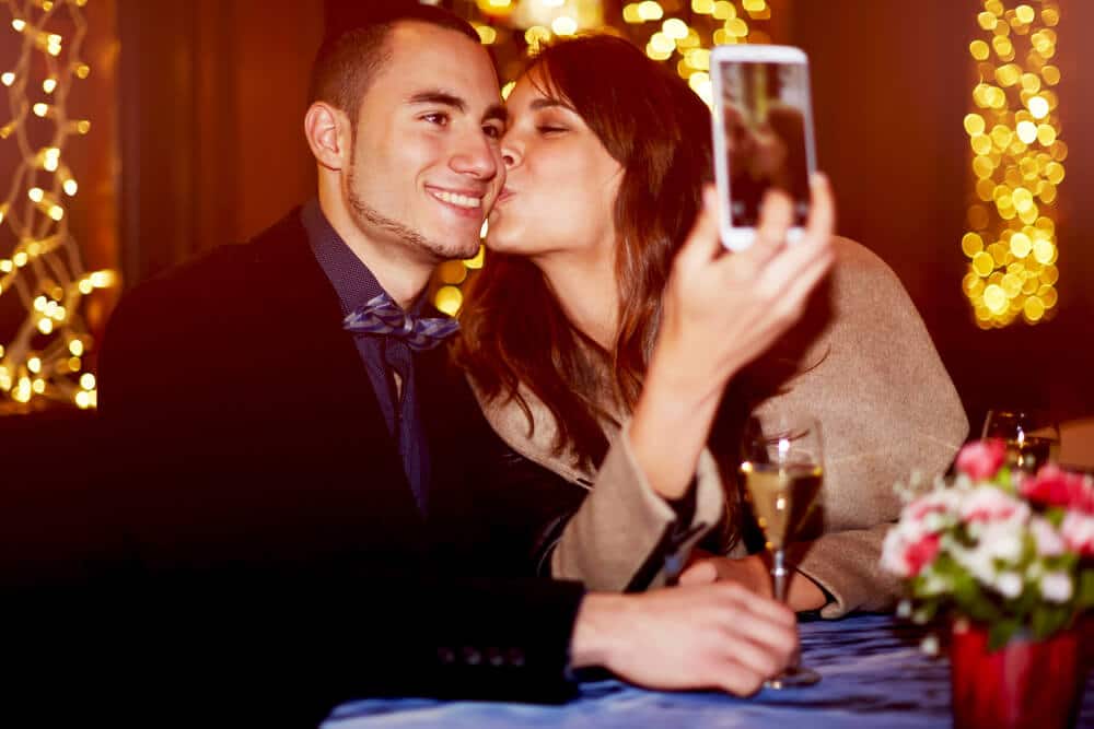 Photo of a Couple Taking a Selfie at Dinner. Click Here for Activities on Valentine’s Day.