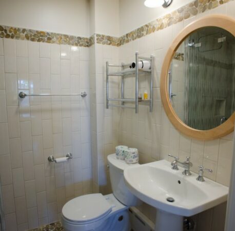 Tiled bathroom, with sink and mirror