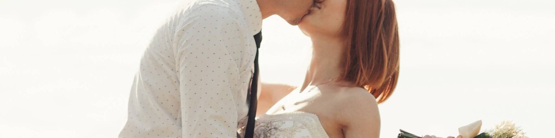 A man and woman kissing at a Maine Wedding Venues.
